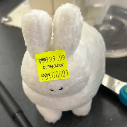 A bunny with a clearance sticker on it's head.
